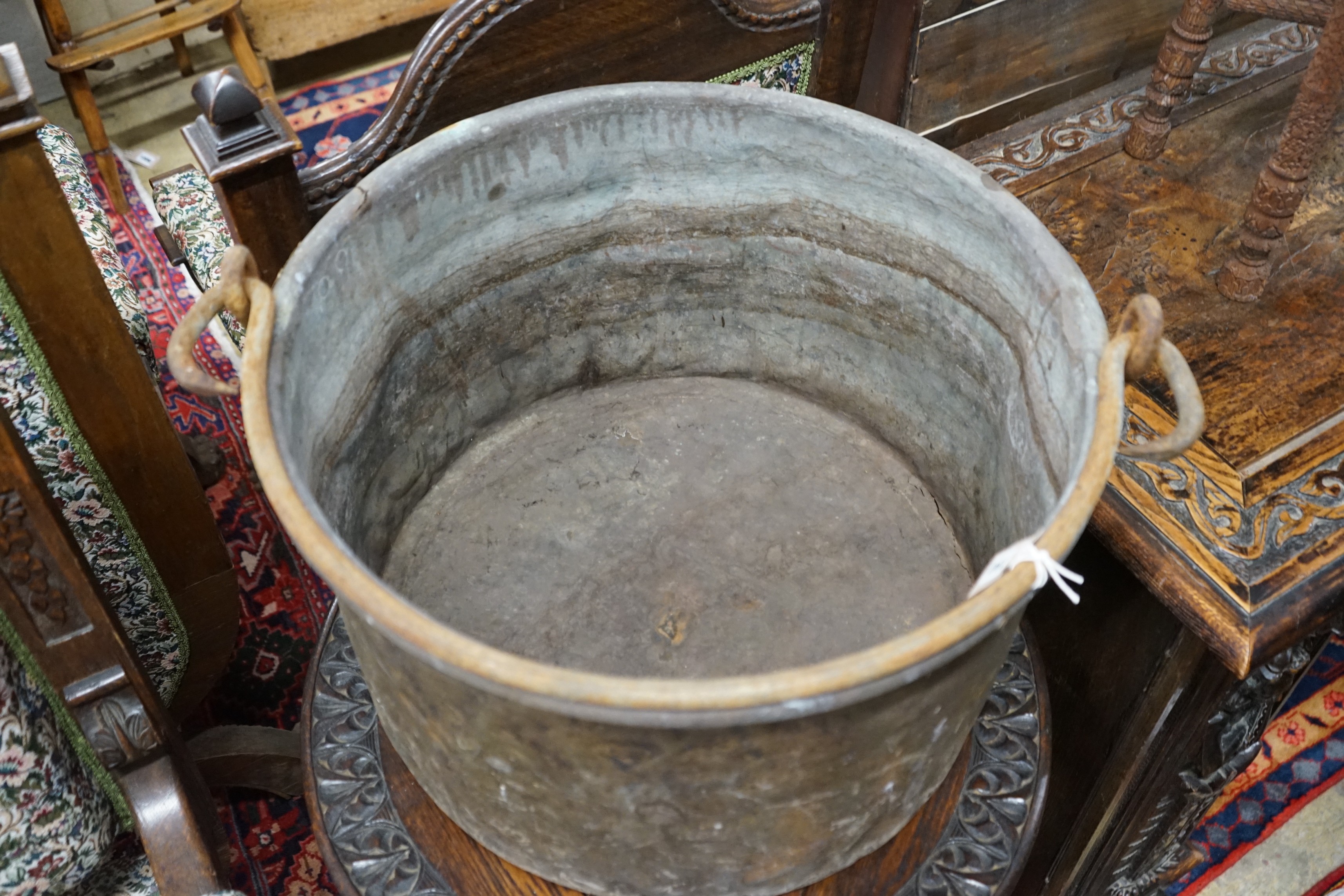 A Victorian brass and wrought iron cauldron with wrought iron swing handle, diameter 56cm, height 35cm